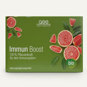 Grüne Box von gse organic supplements Immun Boost Paket, mit geschnittenen und ganzen Grapefruits. Highlights 100% Pflanzenkraft für dein Immunsystem und ein Bio-Label-ideal zur Stärkung des Immunsystems.