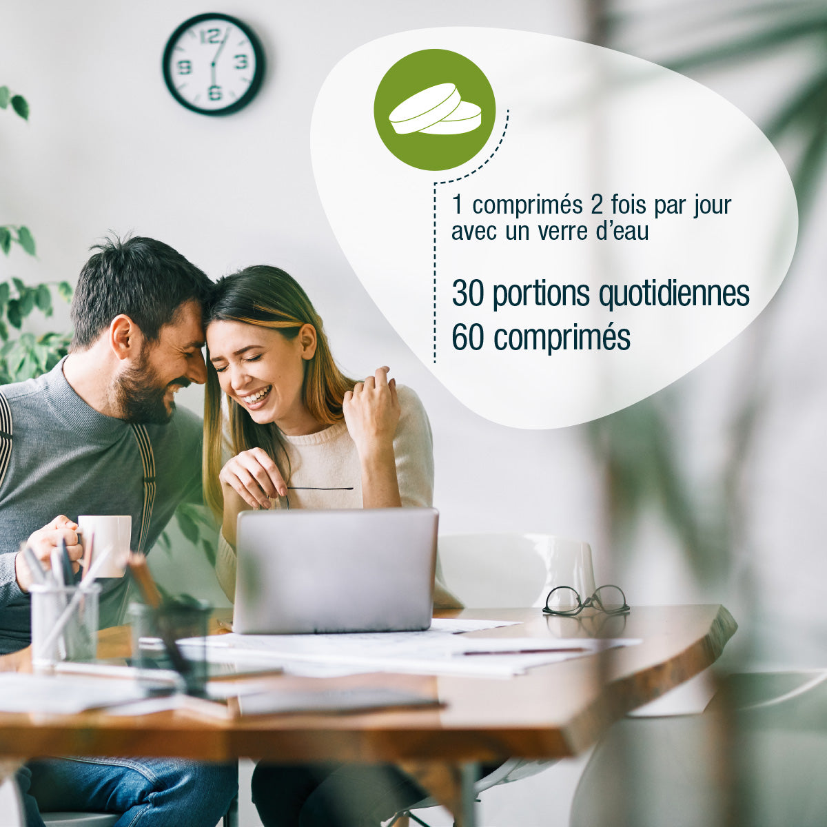 Ein lächelndes Paar sitzt an einem Tisch mit einem Laptop und Getränken, neben einer Grafik für gse.organic.supplements Vitamin B Complex (Bio) FR: 1 Tablette 2x täglich mit Wasser, 30 Portionen, 60 Tabletten. Eine Uhr und Pflanzen vervollständigen die Szene.